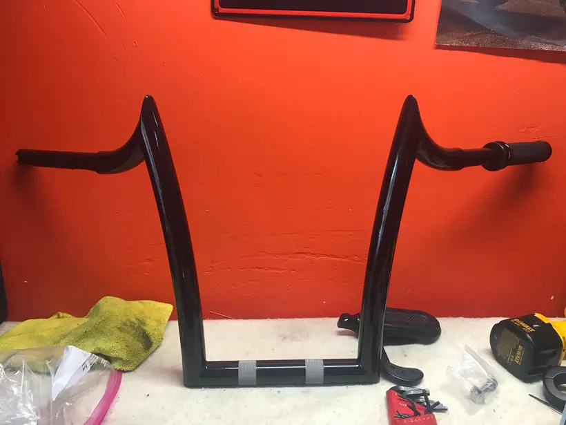 Black ape hangers on the bench ready to be fitted