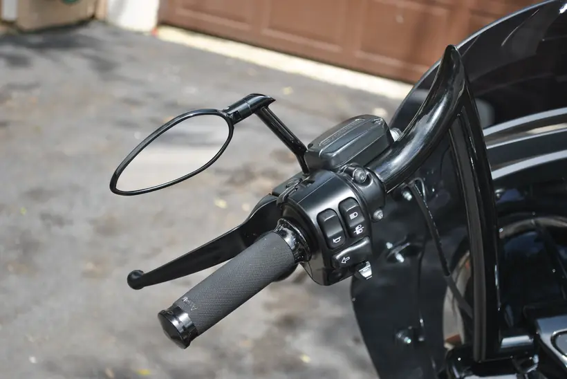 Black hand controls, grip and mirror on a Harley Road King Special
