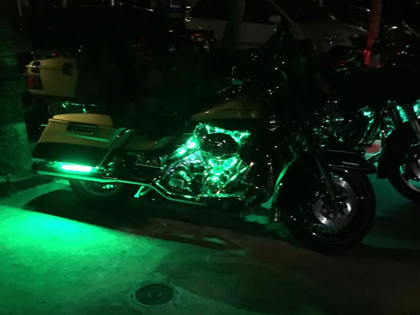 Harley bagger lit with green LED accent lighting at night
