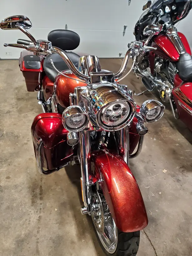 Front of a red CVO Road King with LED headlight and passing lamps