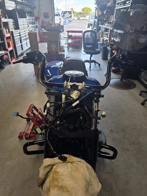 Blue Harley Street Glide torn down to the frame and wiring in the APEX Baggers shop