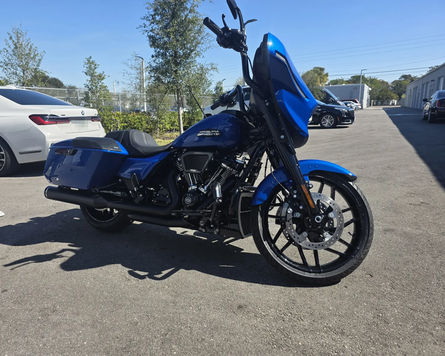 Blue 2024 Harley Street Glide with tall black bars and a 21 inch front wheel