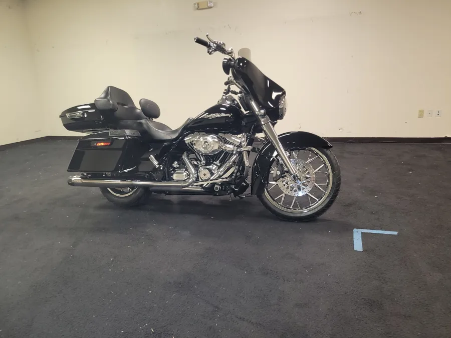 Black Harley bagger with a custom front wheel