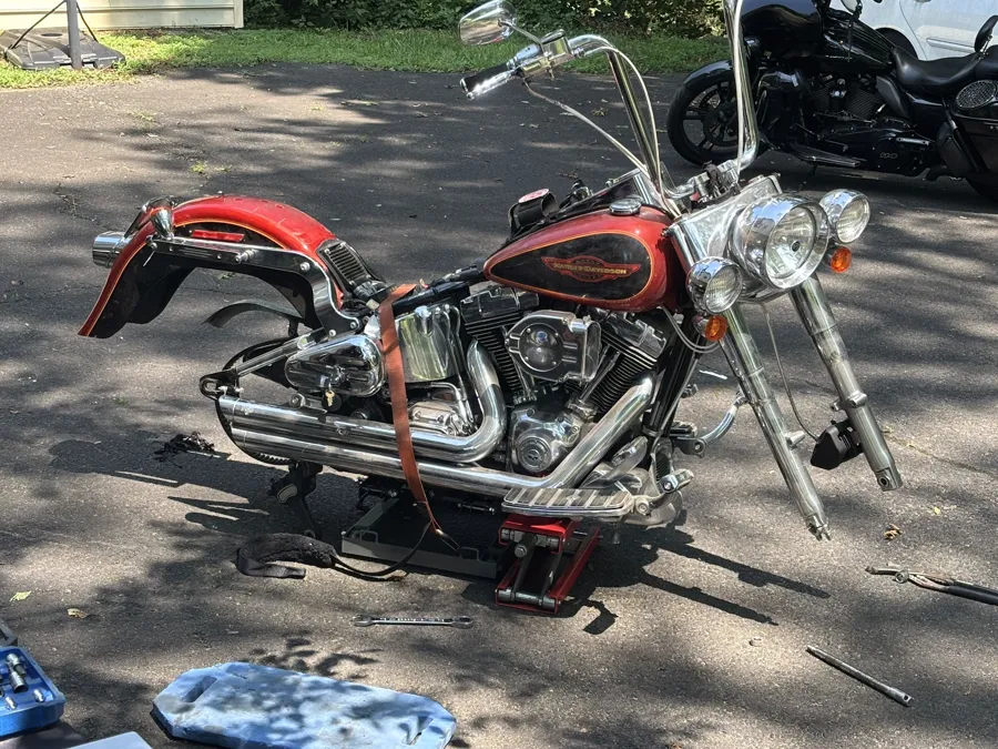 Flamed Harley Softail on the jack during a build