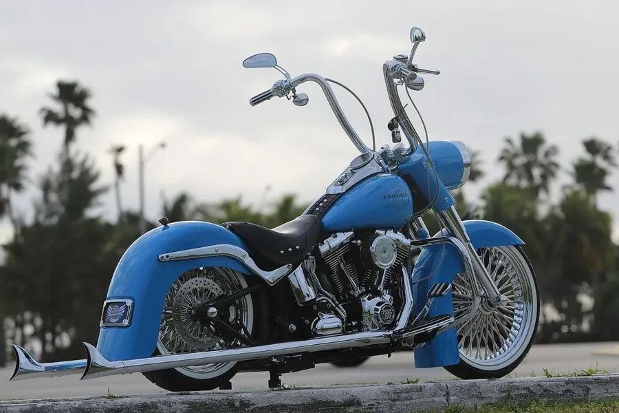 Blue Harley Softail with ape hangers and fishtail exhaust