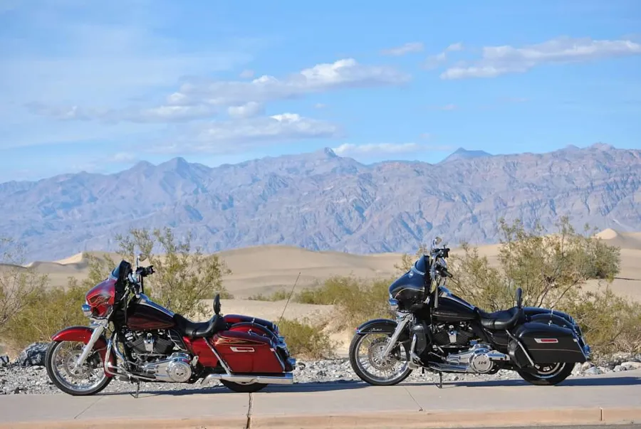 Two Harley baggers parked in the desert